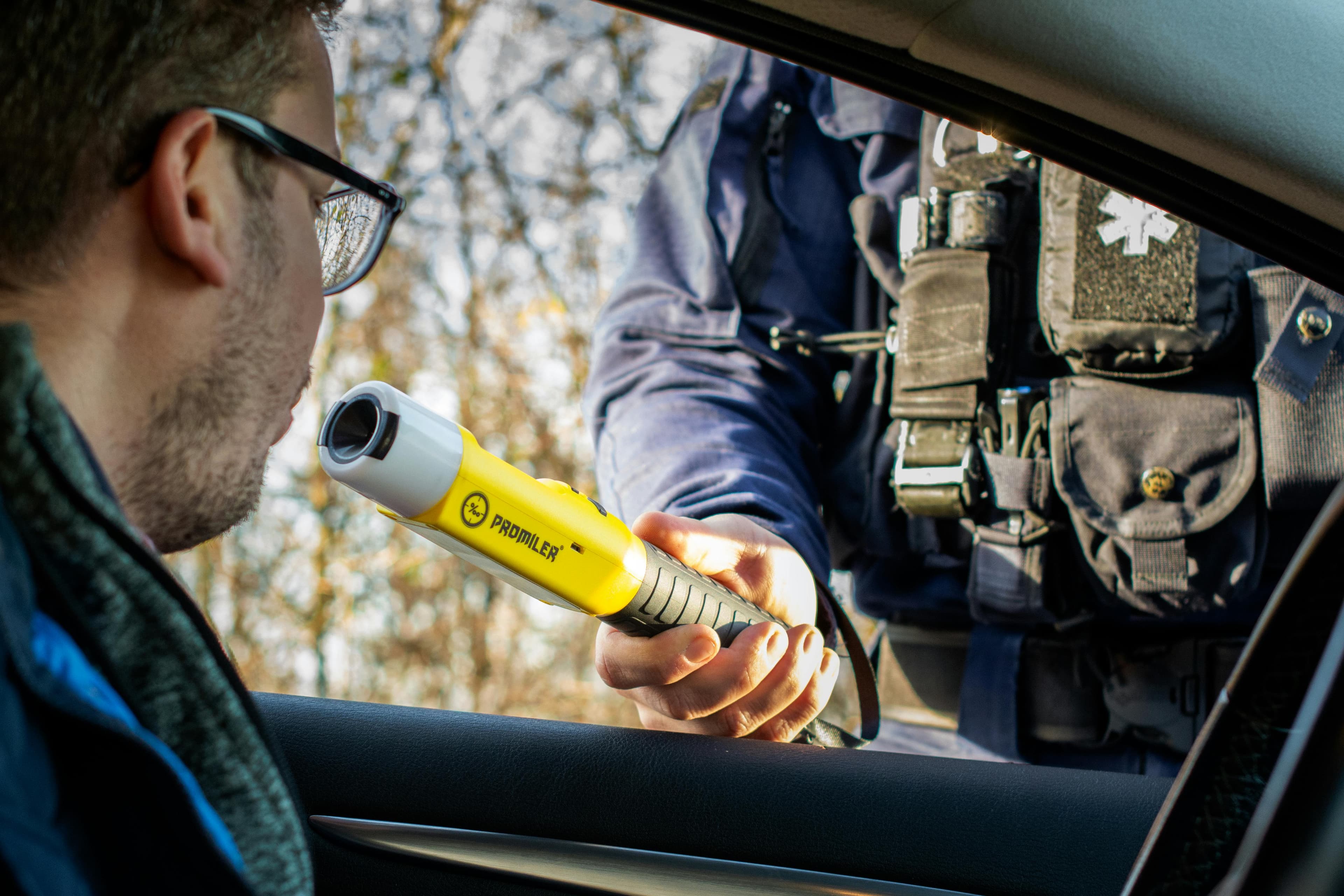 Police officer conducting a roadside breath test
